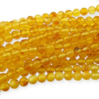 Bursztyn bałtycki koralik nieregularny około 5,7 mm sznur 19 cm